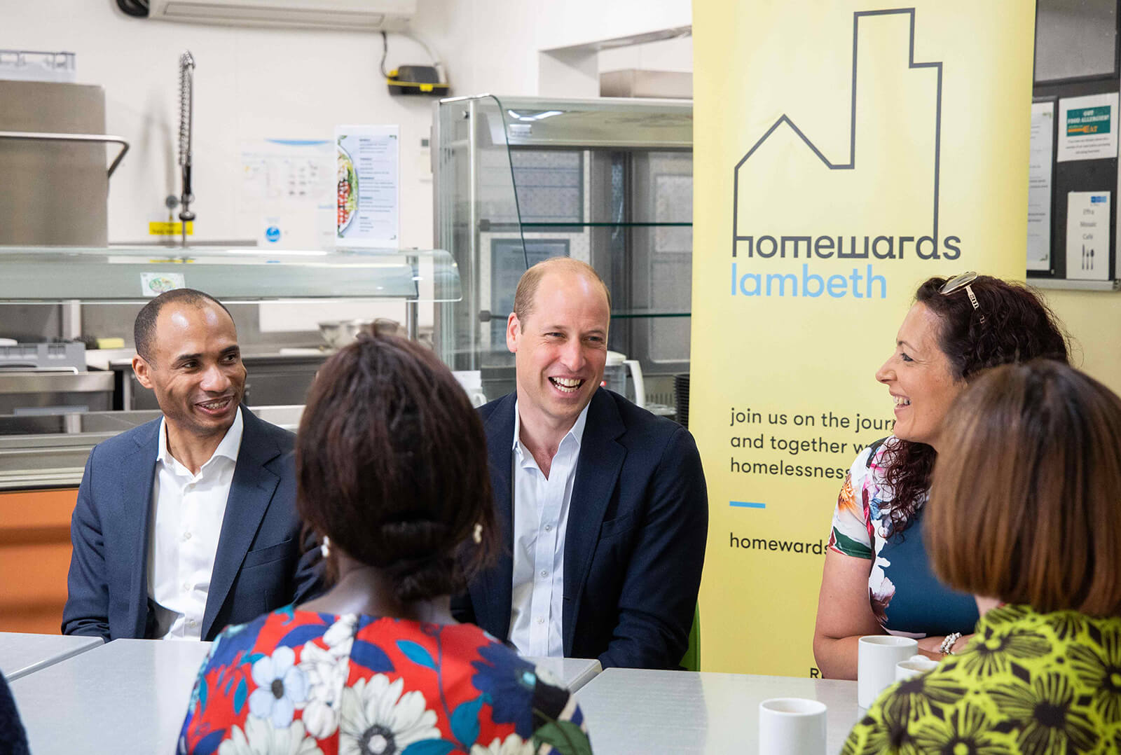 Photo of Prince William smiling with others at 'homewards lambeth'